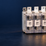 SUTON ETGLR three-fuse switch-disconnector: disconnected product on a dark editorial background