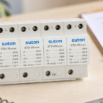 SUTON ETU1 four-module surge protective device, disconnected product on a specification review desk
